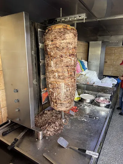 Meat shawarma on a vertical spit in a photo from Reem’s Google Maps listing