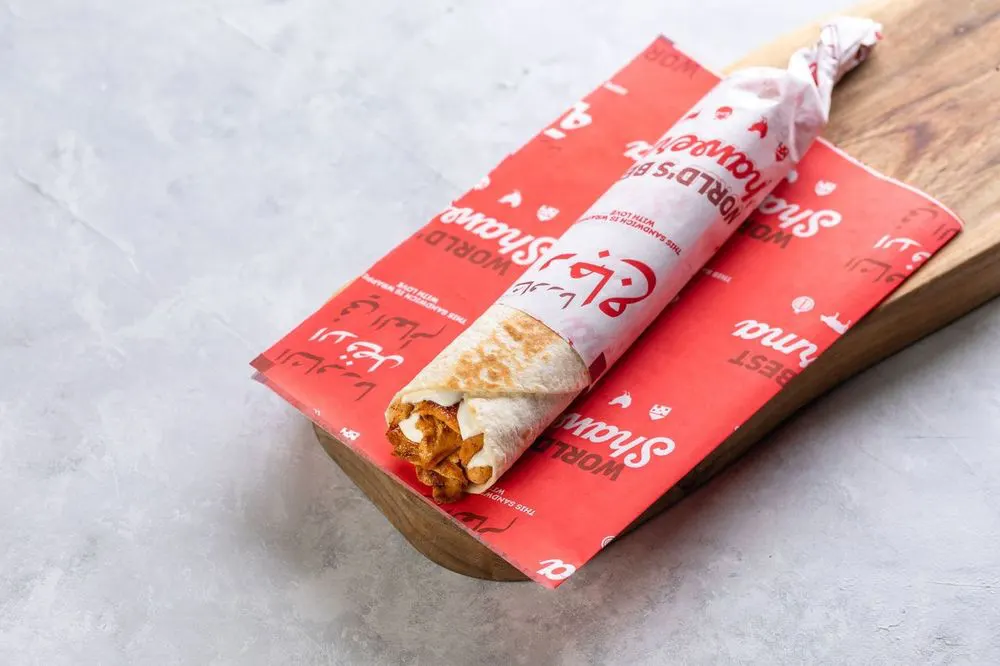 Chicken shawarma saj wrap in Shawerma 3a Saj branded paper, from its Talabat menu