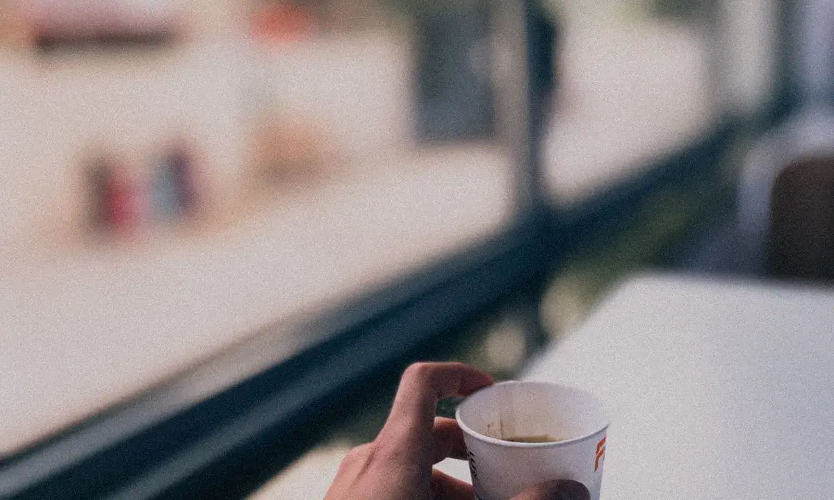 A quiet coffee moment beside a café window in Amman