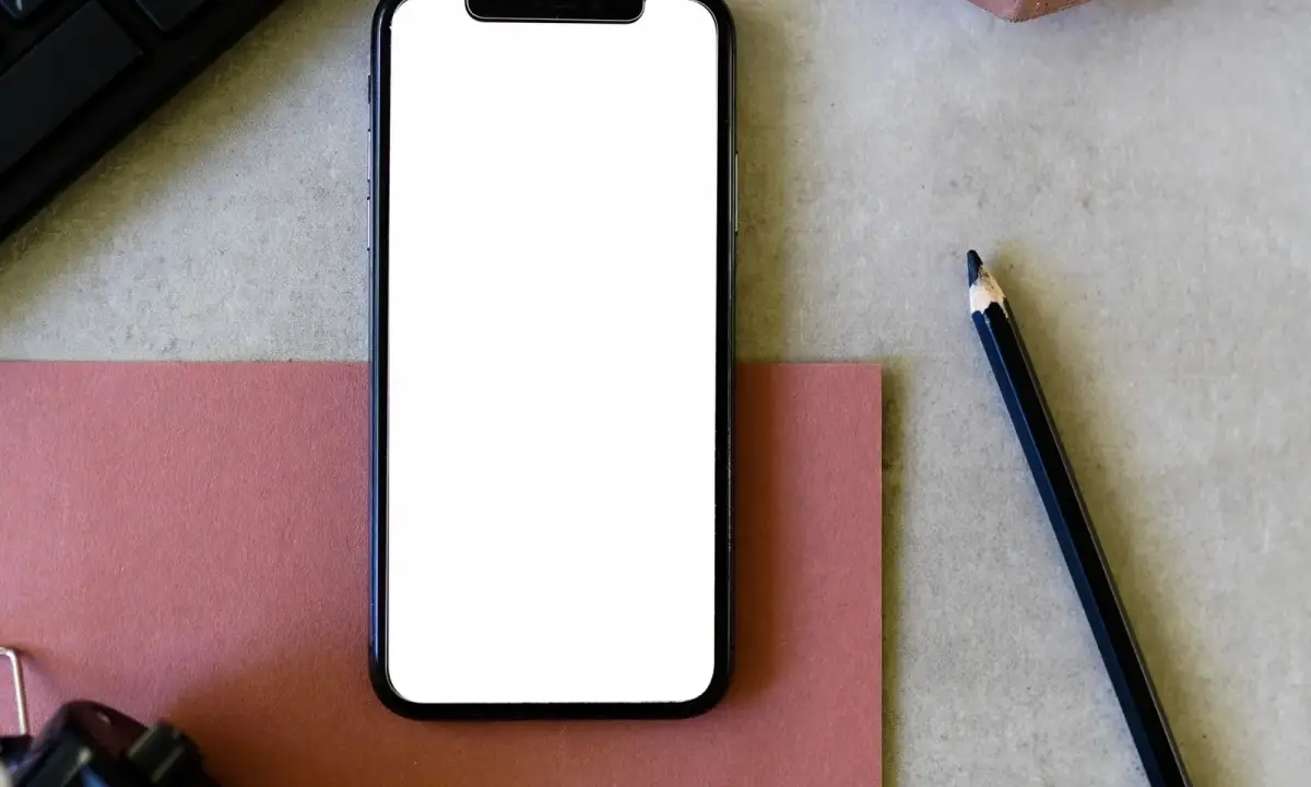 A smartphone beside a clipboard