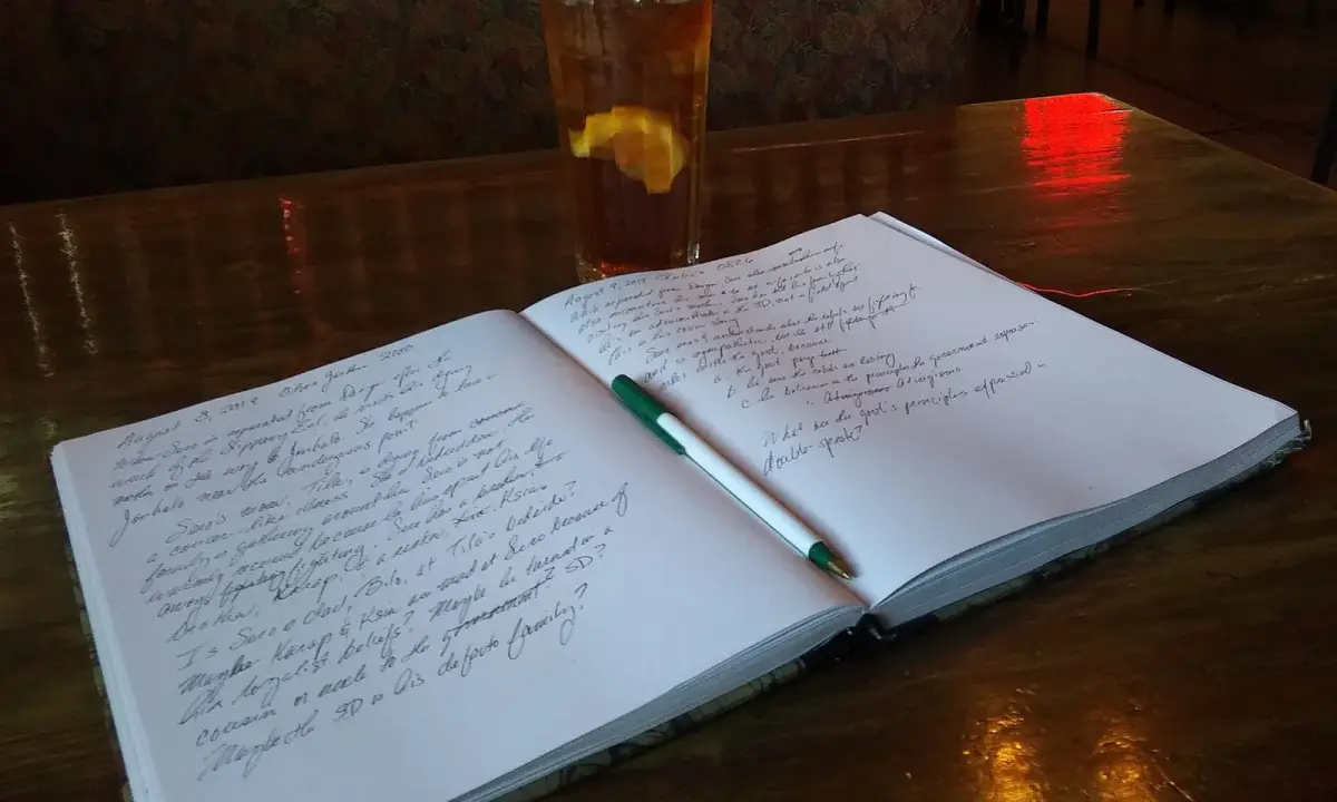 A notebook and pen. Illustrative photograph for organising student documents.