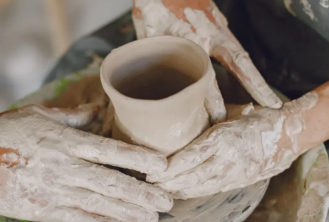 Working with clay at a pottery wheel