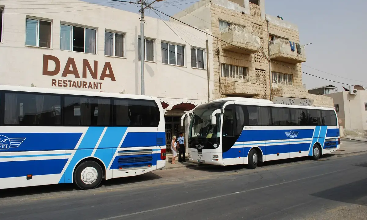 A Jordan Express Tourist Transport (JETT) coach in Madaba, photographed in 2010; historical illustration.