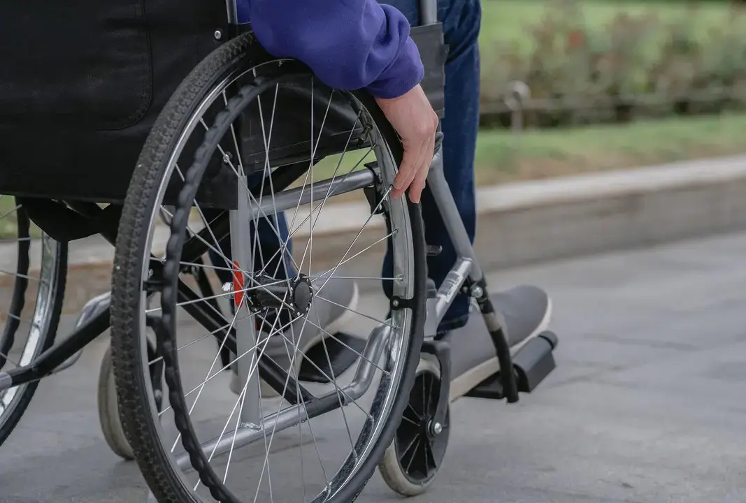 A wheelchair user on a paved path