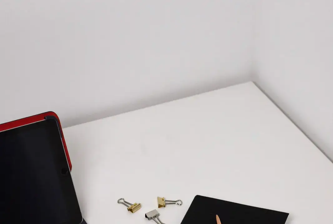 A workspace with a notebook and electronic device