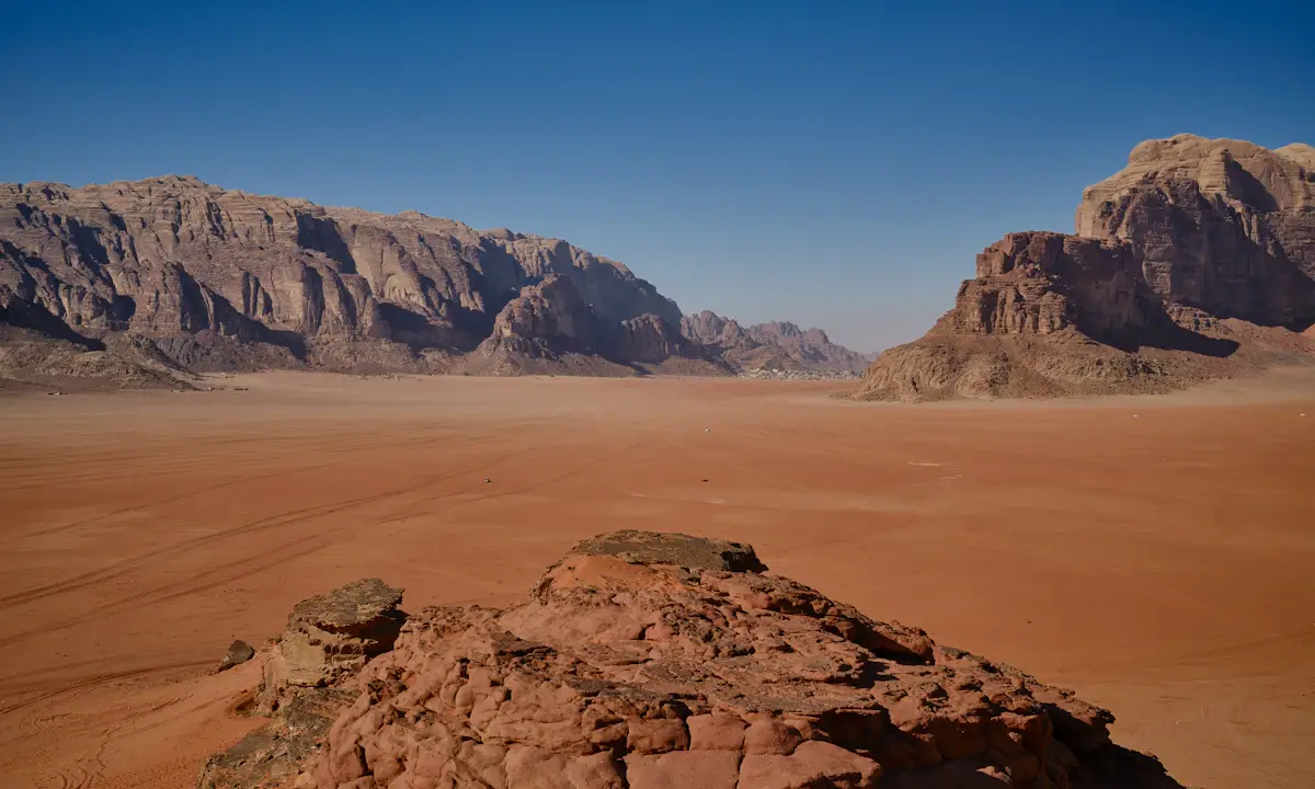 Red desert sands and sandstone mountains in Wadi Rum